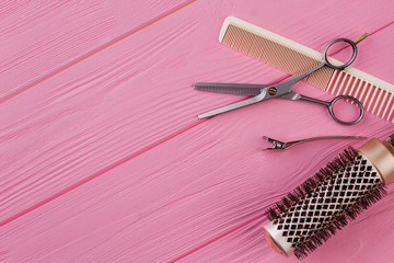 Hairdresser combs and scissors on pink background. Tools for hair cutting. Space for text.
