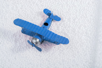 Toy airplane on little  white polystyrene balls