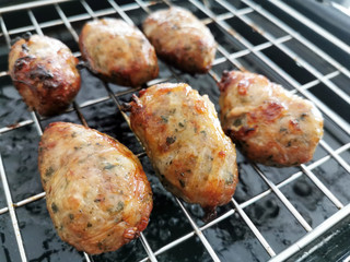 Traditional Cypriot food. Sheftalia : Cypriot Lamb and Pork Sausages on a metal grill.