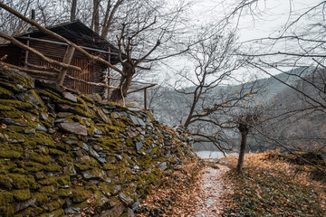 Cottage on the rock. Autumn landscape with yellow-orange and fallen leaves. Nature Trail Svatojanske proudy. Slapy, Czech Republic. 