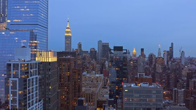 Aerial drone footage of New York skyline, at dusk, with forward camera motion along the 29th street