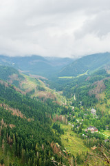Fototapeta premium Tatry mountains covered with beautiful forests and covered with thick fog and clouds