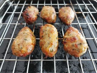 Traditional Cypriot food. Sheftalia : Cypriot Lamb and Pork Sausages on a metal grill.