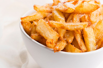 Bowl of potatoe fries on a white background
