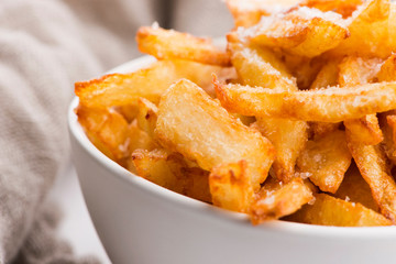 Bowl of potatoe fries on a white background