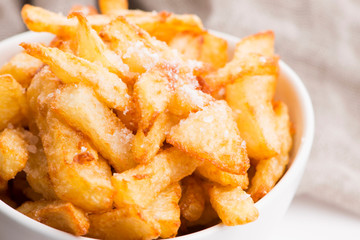 Bowl of potatoe fries on a white background