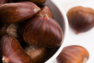 Bowl of chestnuts on a white background