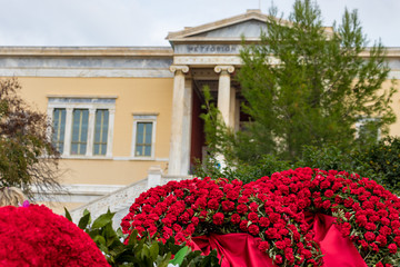 Athens, Greece - November 17th, 2019: Red flowers next the Polytechnio University to conmemorate the 46th aniversary of the uprising students against the Greek junta in 1973.