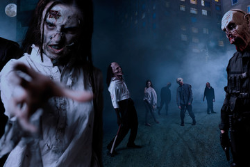 Zombies with bloody faces on night street, monster