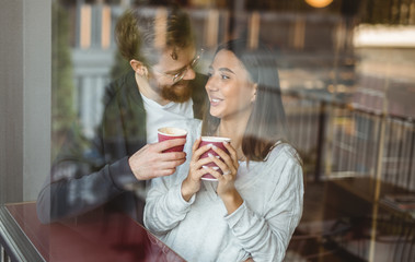 Happy couple enjoying coffee during date