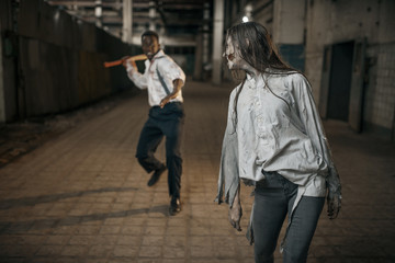 Obraz na płótnie Canvas Man with axe attacked female zombie
