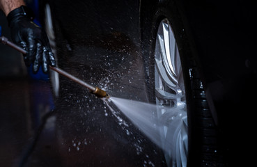 car wash, capturing the water sprayed at the wheels 