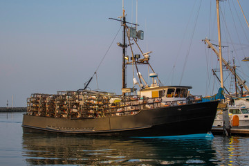 Crab boats in dock with crab pots load on the deck waiting for the 2019 crab season to open