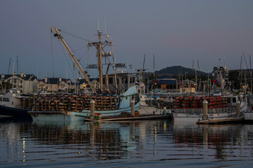 Crab boats in dock with crab pots load on the deck waiting for the 2019 crab season to open