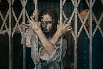 Obraz na płótnie Canvas Zombie behind the bars of the elevator, death trap