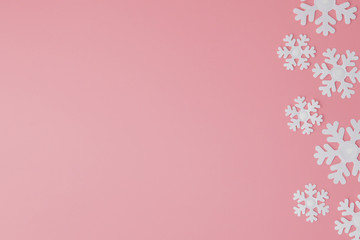 Winter pattern made of snowflakes and on pink background. Christmas concept. Flat lay. Copy space for your text