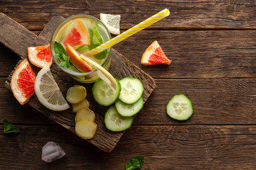 Bottles of fresh detox water on wooden table