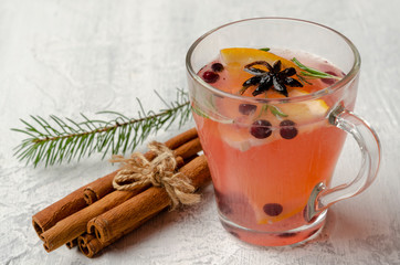 Hot tea with orange slices, cranberries and rosemary