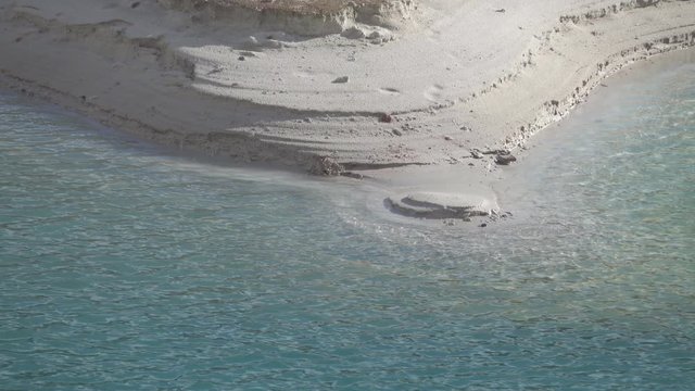 The water in the river falls quickly after the flood. Water levels of previous days are visible. Sandy beach as a kind of water gauge rail (water level scale)