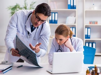 The two doctors examining x-ray images of patient for diagnosis