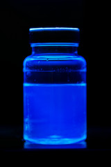 Escherichia coli growing in a broth containing a fluorescent compound. This sample is giving a positive result.