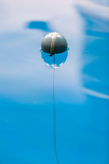Obraz premium A float with line showing reflection in calm water.
