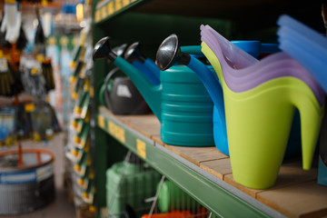 Watering cans on the shelf, shop for floristry