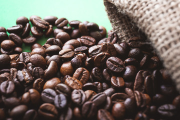 Roasted coffee beans on color background, closeup