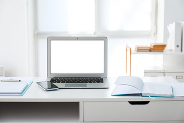 Fototapeta na wymiar Modern stylish workplace with laptop in office