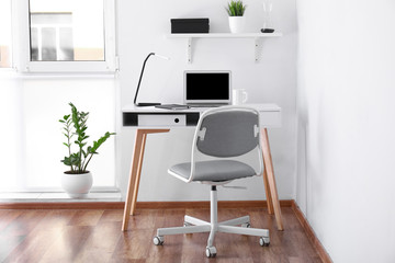 Modern stylish workplace with laptop in office