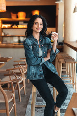 Happy woman enjoying coffee in cafe