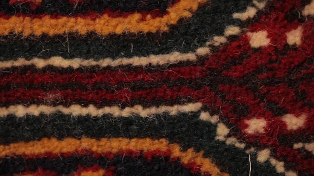 Large oriental rug with colorful patterns. Handmade rug production, carpet close-up with all the details