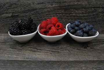 three dishes of fresh berries