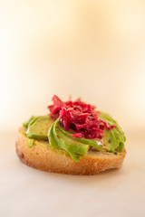 Sauerkraut on the top of avocado and sourdough bread