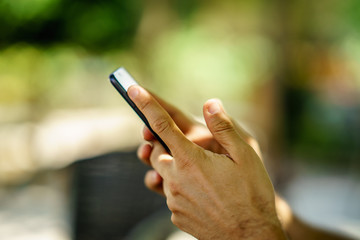 Close up of human hand holding smart phone.