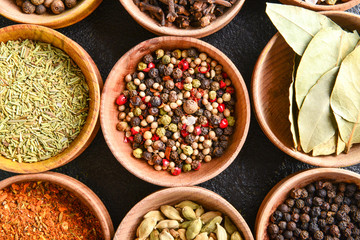 Bowls with many different spices on table
