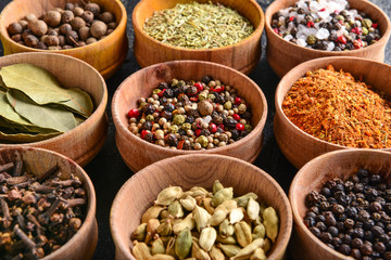 Bowls with many different spices on table