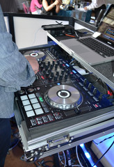 disc jockey at mixing board during party
