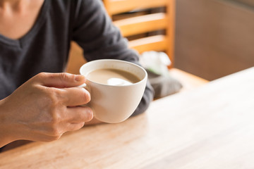 woman hold a cup a coffee