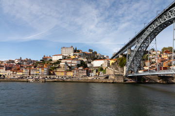 Fototapeta na wymiar Landscape of Porto, Portugal with Douro River, city skyline, and bridge under blue sky