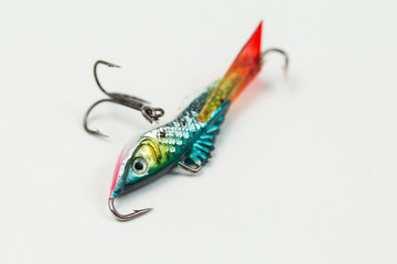 Fishing spinners and wobblers multi-colored on a background of artificial green grass. 