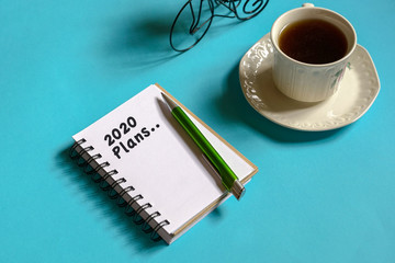 2020 new year goal, plan, action text on note pad. Top view or flat lay.