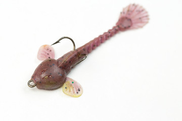 Fishing spinners and wobblers multi-colored on a background of artificial green grass. 