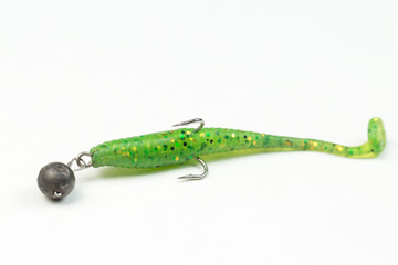 Fishing spinners and wobblers multi-colored on a background of artificial green grass. 