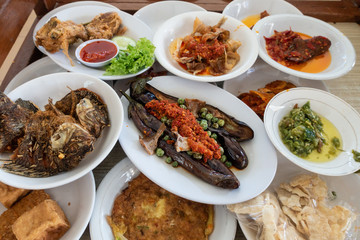 The famous "Nasi Padang" in Indonesia. Rice is served with many dishes like chicken, beef, mix vegetables and eggs.