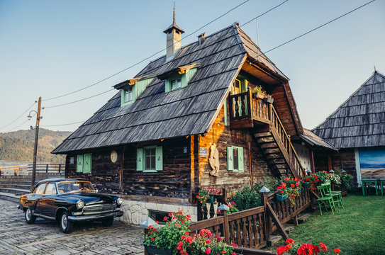 Drvengrad, Serbia - August 28, 2015. Old Volga car in front of wooden house of Drvengrad village built by Emir Kusturica