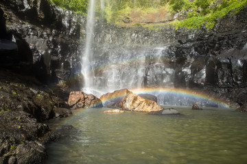 Fototapeta na wymiar Double Rainbow at the Base of Waterfall