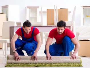 Two contractor employees moving personal belongings