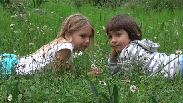 Akyaka, Mugla, Turkey - 10th of November 2019: 4K Adorable girl and boy whisper secrets resting in grass