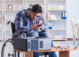 Computer repairman on wheelchair working